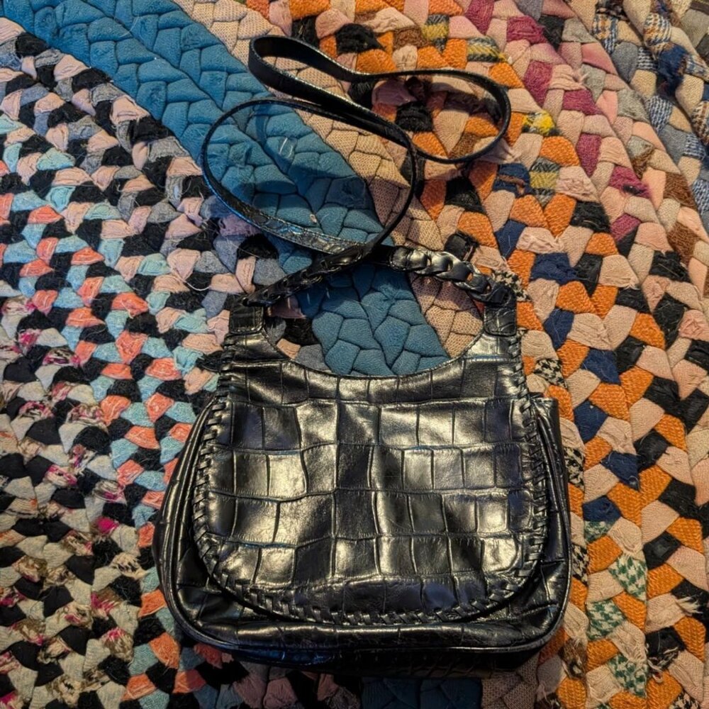 Black leather crossbody bag with a touch of grunge charm #grungevibes